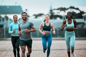 Sculpting Sleek Arms: The Essential Role of Cardio in Toning Without Bulking Up 3 image of people running to incorporate cardio Poole exercise into their life to help tone arms and body.